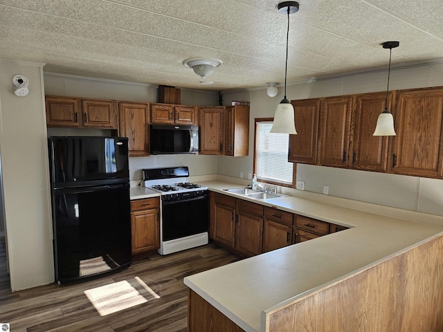 4151 E Jordan Rd Lot 51, Mount Pleasant, MI 48858 - kitchen with freestanding refrigerator, stainless steel microwave, gas range oven, brown cabinetry, and dark wood finished floors