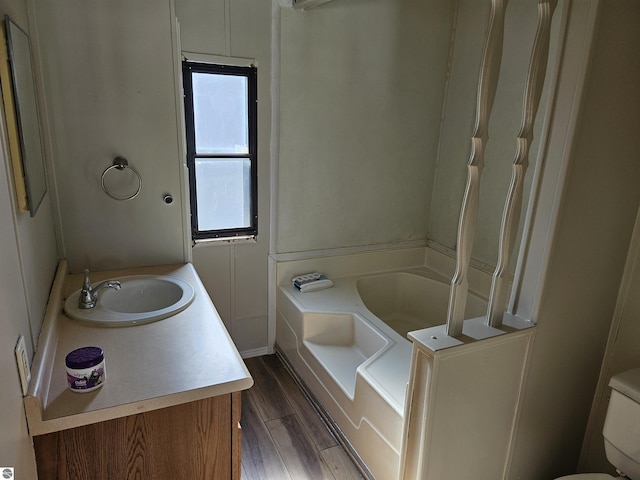 4151 E Jordan Rd Lot 51, Mount Pleasant, MI 48858 - bathroom with a tub to relax in, wood finished floors, and vanity