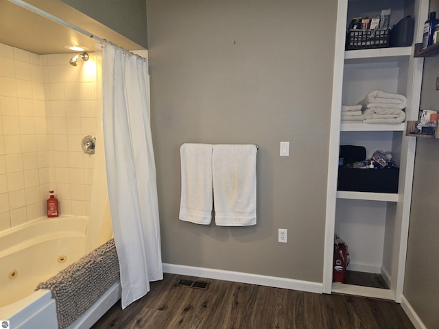 3962 Power Dr, Mikado, MI 48745 - bathroom featuring wood finished floors and a combined bath / shower with jetted tub