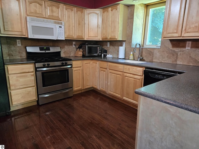 3962 Power Dr, Mikado, MI 48745 - kitchen with white microwave, stainless steel gas stove, and light brown cabinetry