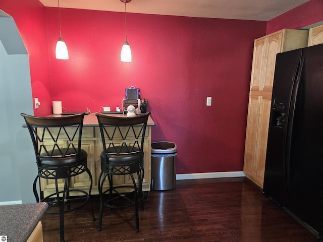 3962 Power Dr, Mikado, MI 48745 - bar area with black refrigerator with ice dispenser, wood finished floors, and hanging light fixtures