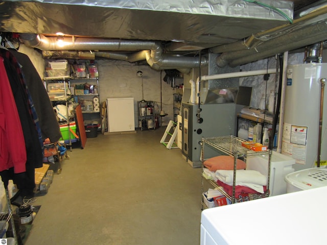 705 E Bay St, East Tawas, MI 48730 - unfinished basement with water heater, heating unit, and washer / dryer