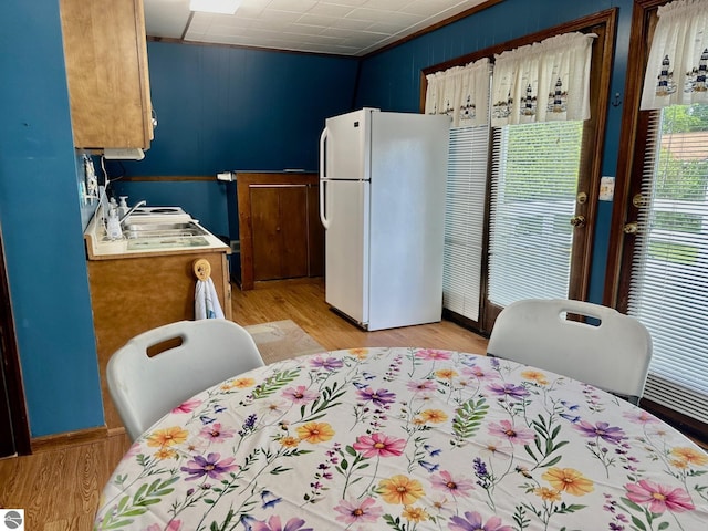 3775 W Cedar Lake Rd, Greenbush, MI 48738 - kitchen with freestanding refrigerator, light wood finished floors, and brown cabinetry