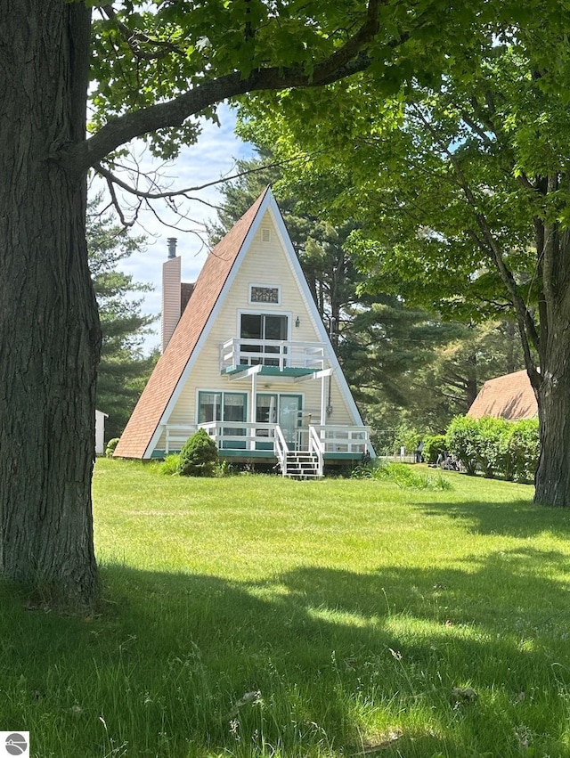3775 W Cedar Lake Rd, Greenbush, MI 48738 - view of front of home with a chimney, a front lawn, and a wooden deck