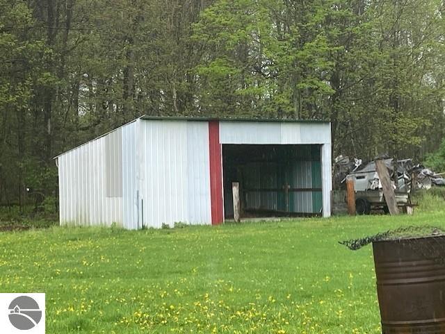 802 W 4th Rd, Buckley, MI 49620 - view of pole building with a yard and a wooded view