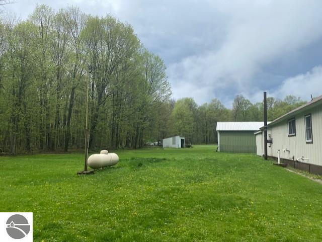 802 W 4th Rd, Buckley, MI 49620 - view of grassy yard featuring an outdoor structure