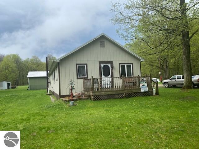 802 W 4th Rd, Buckley, MI 49620 - view of front facade with a deck and a front yard