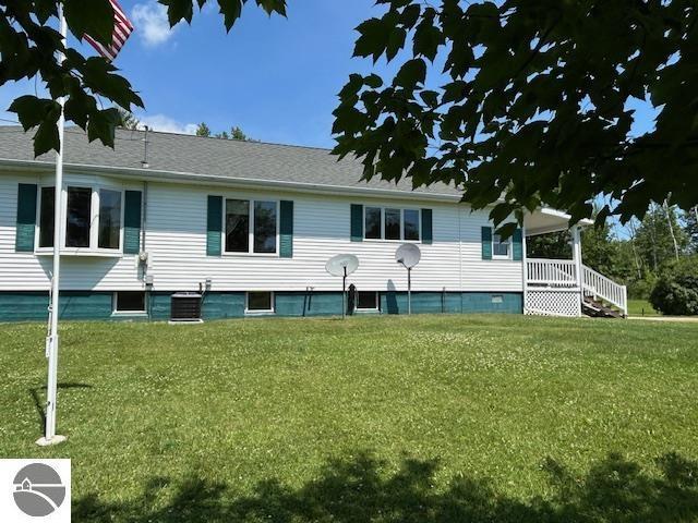 2393 Oates Rd, Tawas City, MI 48763 - rear view of property with a yard