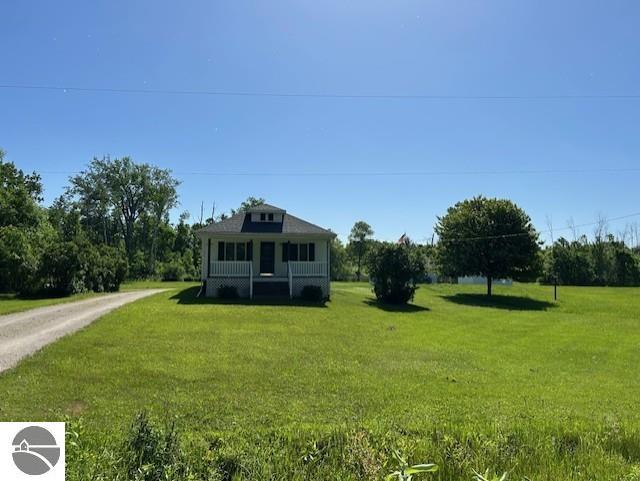 2393 Oates Rd, Tawas City, MI 48763 - view of front of property with a front yard and driveway
