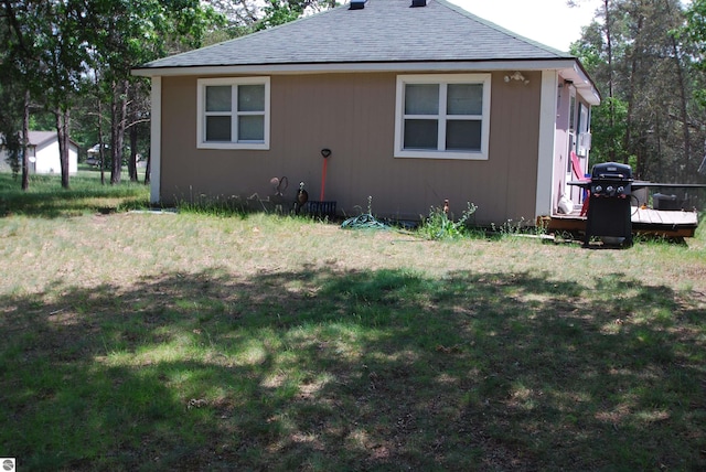 1159 Jones Rd, Saint Helen, MI 48656 - view of side of property with a shingled roof and a yard