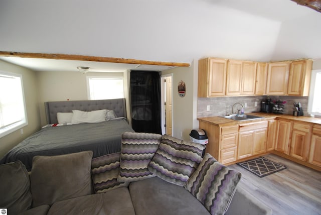 1159 Jones Rd, Saint Helen, MI 48656 - bedroom with multiple windows, light wood-type flooring, and lofted ceiling