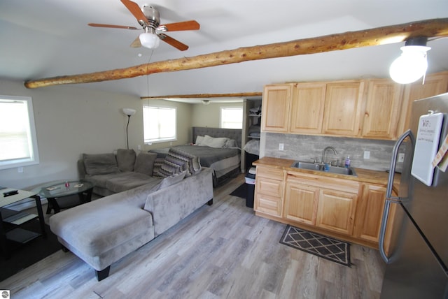 1159 Jones Rd, Saint Helen, MI 48656 - kitchen featuring freestanding refrigerator, light brown cabinets, beamed ceiling, open floor plan, and tasteful backsplash