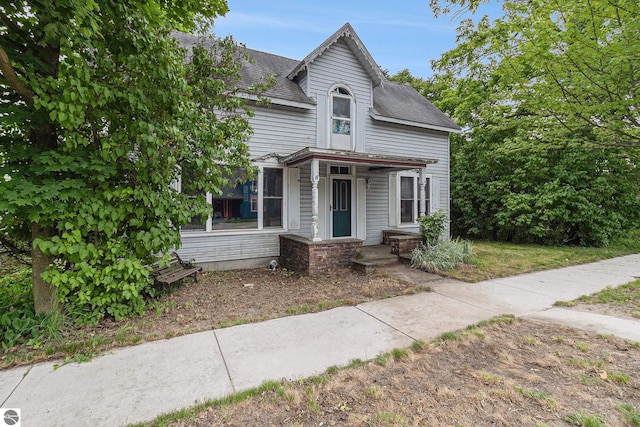 718 Forest Ave, Frankfort, MI 49635 - victorian house with roof with shingles