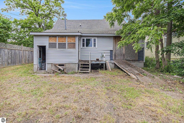 718 Forest Ave, Frankfort, MI 49635 - rear view of house featuring a deck and roof with shingles