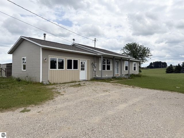 2082 Dusty Trl, Kingsley, MI 49649 - ranch-style house with driveway, a shingled roof, and a front yard