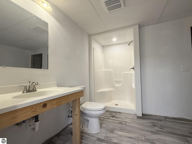 2082 Dusty Trl, Kingsley, MI 49649 - full bathroom featuring a paneled ceiling, a shower stall, wood finished floors, and vanity