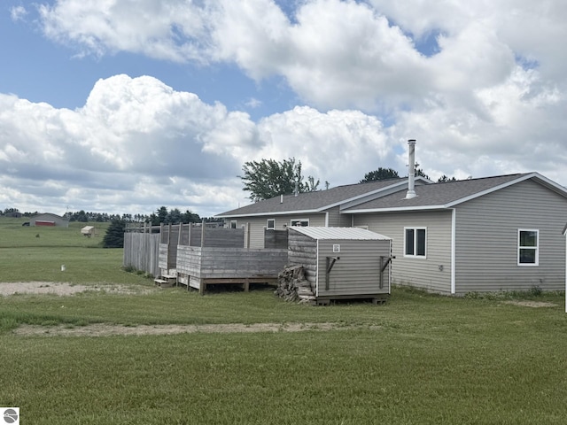 2082 Dusty Trl, Kingsley, MI 49649 - rear view of house with a lawn, a deck, and roof with shingles
