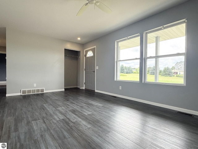 2082 Dusty Trl, Kingsley, MI 49649 - unfurnished living room with a ceiling fan, dark wood finished floors, and recessed lighting