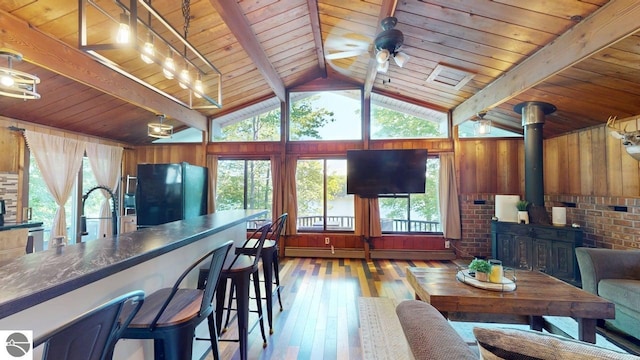 7851 White Birch Dr, Farwell, MI 48622 - dining space with wooden ceiling, wood-type flooring, a wood stove, and a baseboard heating unit