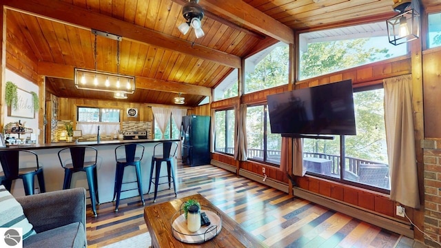 7851 White Birch Dr, Farwell, MI 48622 - living area with light wood-style flooring, healthy amount of natural light, wood ceiling, a ceiling fan, and wood walls