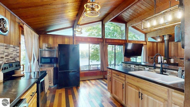 7851 White Birch Dr, Farwell, MI 48622 - kitchen with black appliances, baseboard heating, dark countertops, wood ceiling, and light wood finished floors
