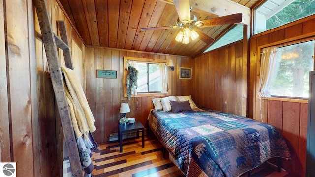 7851 White Birch Dr, Farwell, MI 48622 - bedroom with wooden ceiling, wooden walls, wood finished floors, lofted ceiling, and a baseboard heating unit
