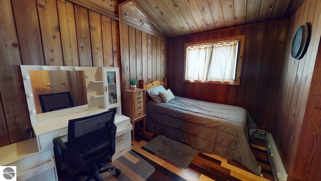 7851 White Birch Dr, Farwell, MI 48622 - bedroom with baseboard heating, wooden walls, an office area, wood ceiling, and wood finished floors