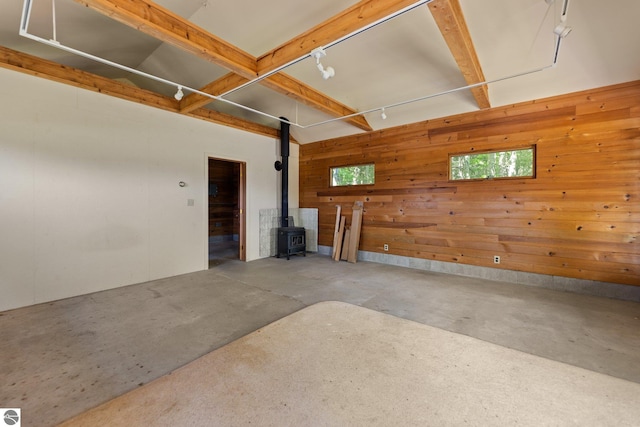 12271 E Woolsey Lake Rd, Northport, MI 49670 - garage with wooden walls and a wood stove