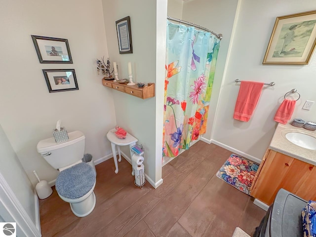 5670 N Harrison Ave, Harrison, MI 48625 - bathroom with wood finished floors, vanity, and a shower with shower curtain