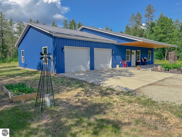 5670 N Harrison Ave, Harrison, MI 48625 - garage with a porch and driveway
