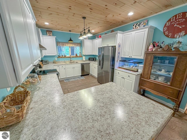 5670 N Harrison Ave, Harrison, MI 48625 - kitchen with stainless steel appliances, wooden ceiling, under cabinet range hood, a peninsula, and white cabinetry