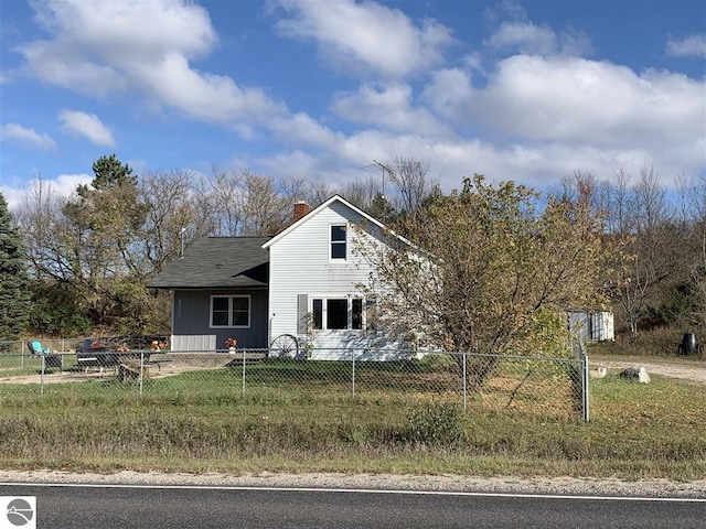 13333 S Coleman Rd, Empire, MI 49630 - view of front of house featuring a chimney and board and batten siding