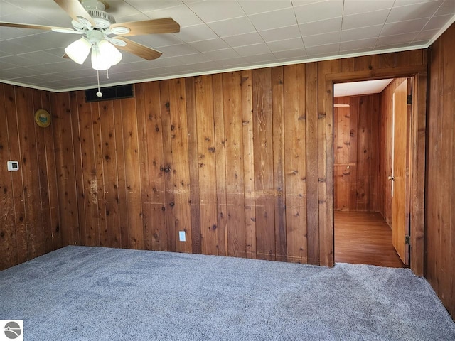 13333 S Coleman Rd, Empire, MI 49630 - carpeted spare room with wooden walls and ceiling fan