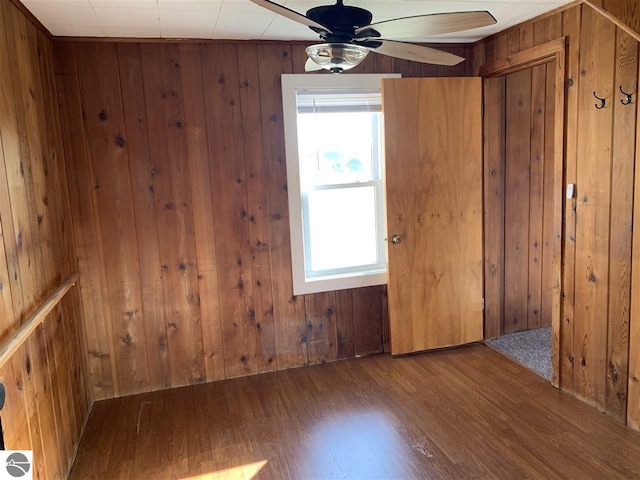 13333 S Coleman Rd, Empire, MI 49630 - empty room featuring wood finished floors, a ceiling fan, and wood walls