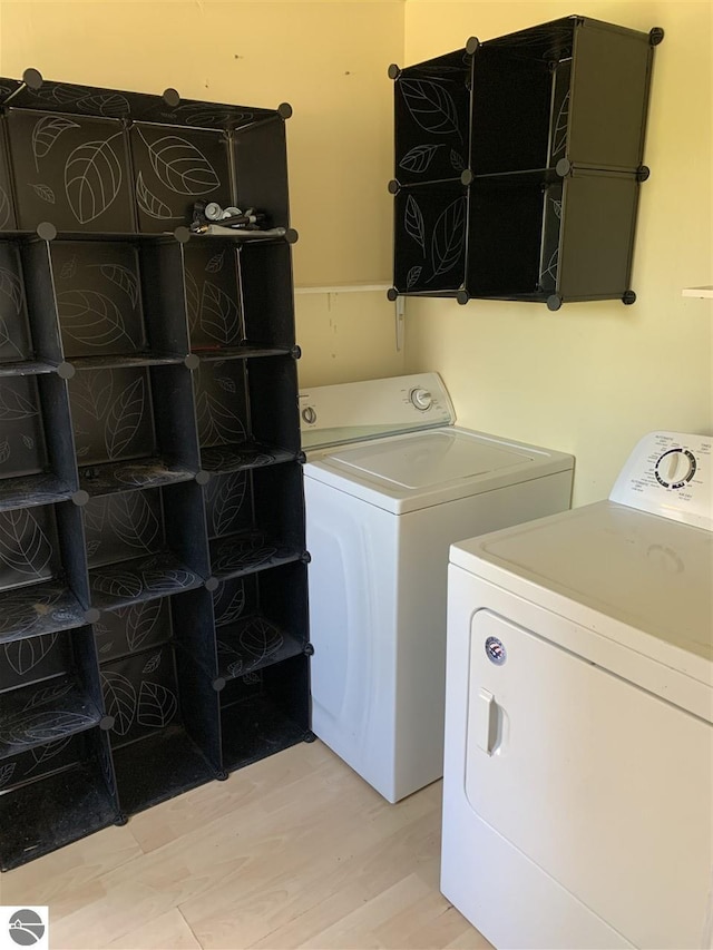 13333 S Coleman Rd, Empire, MI 49630 - laundry room with independent washer and dryer and light wood-type flooring