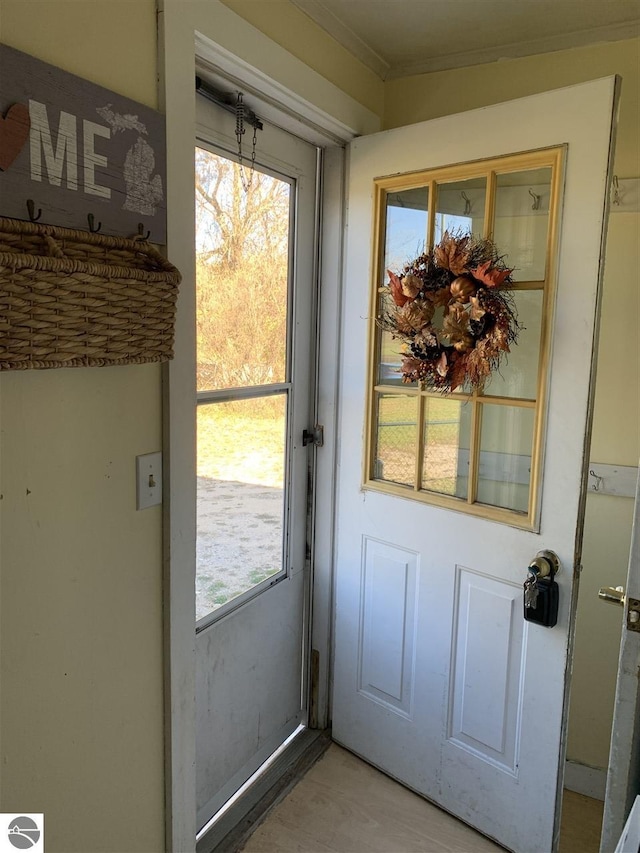13333 S Coleman Rd, Empire, MI 49630 - doorway with ornamental molding and light wood finished floors
