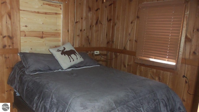 bedroom featuring wood walls