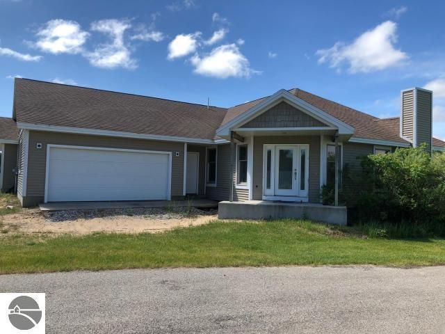 view of front of property featuring covered porch and a garage