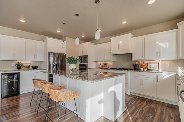 kitchen featuring wine cooler, white cabinetry, dark hardwood / wood-style flooring, and a kitchen island