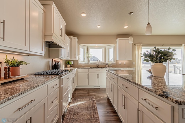 kitchen featuring white cabinetry, a textured ceiling, and dark wood-type flooring