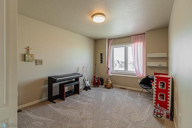 misc room featuring a textured ceiling and carpet flooring