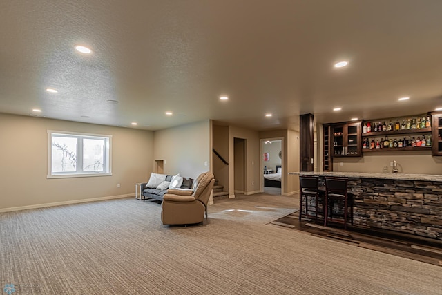 living room with sink, carpet floors, and a textured ceiling