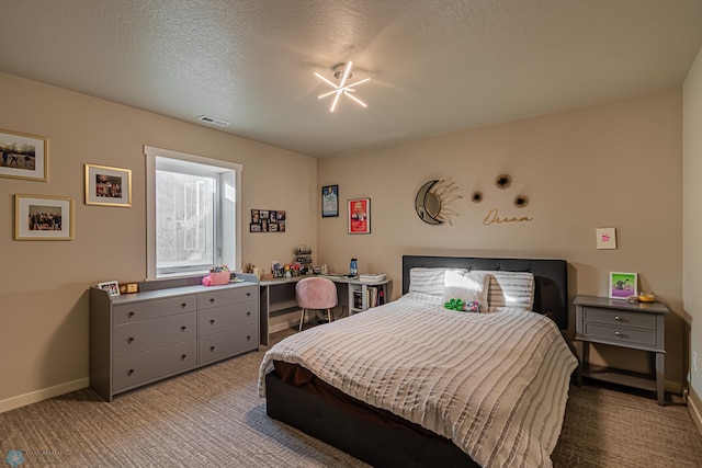 bedroom with a textured ceiling and carpet flooring