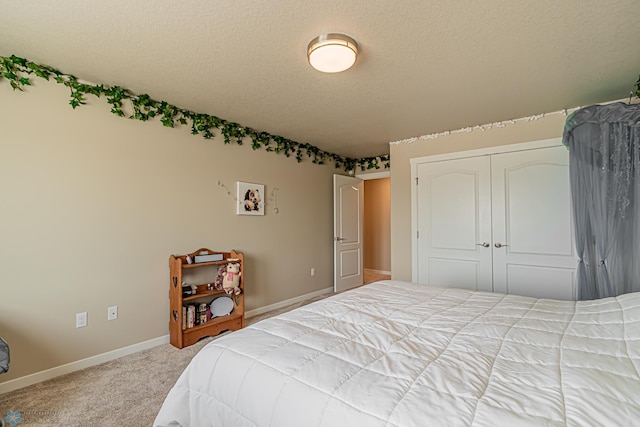 carpeted bedroom with a closet and a textured ceiling