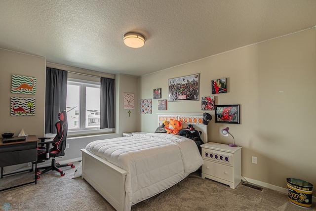 bedroom featuring a textured ceiling and carpet flooring