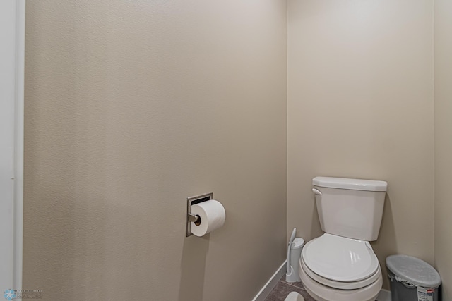 bathroom featuring toilet and tile floors