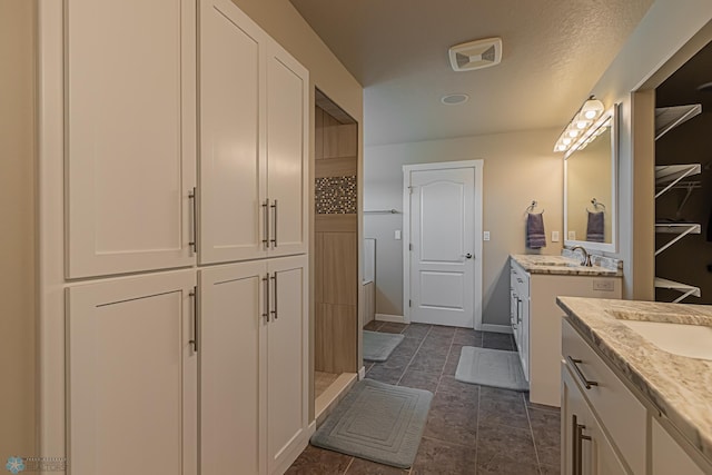 bathroom with double vanity and tile flooring