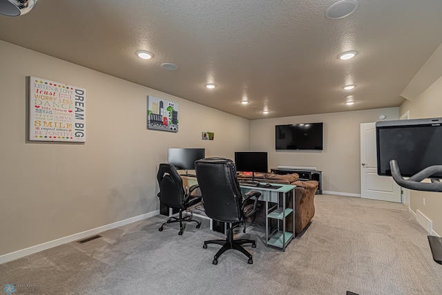 carpeted home office with a textured ceiling