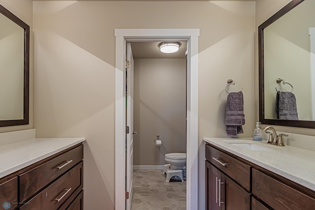 bathroom with tile floors, toilet, and large vanity