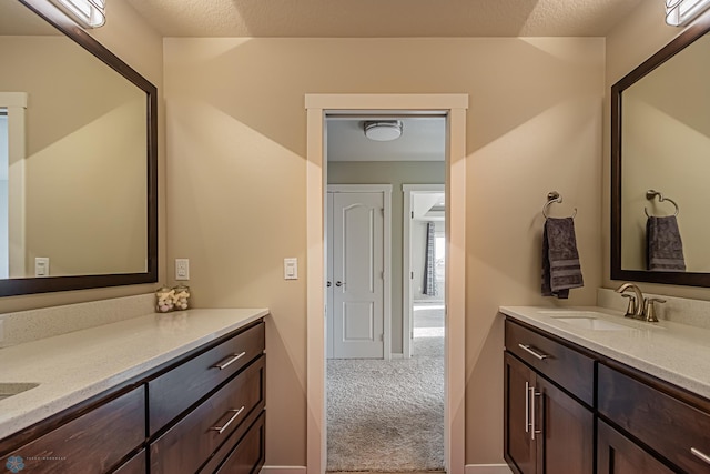 bathroom with vanity and a textured ceiling